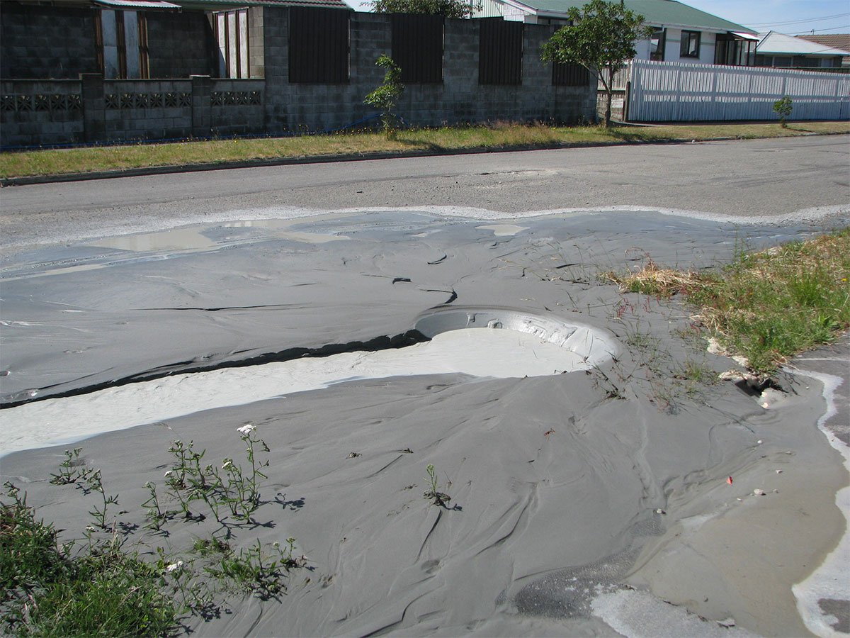 Liquefaction causing silt to bubble up through the road.