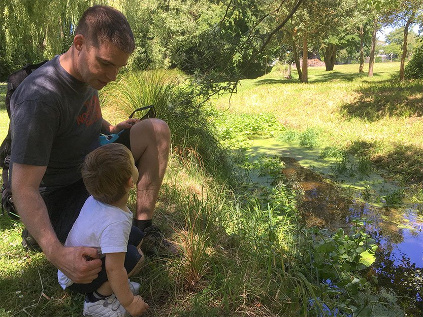 Father and son by a stream
