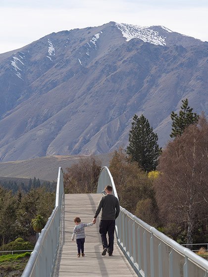 Father and son cross a bridge