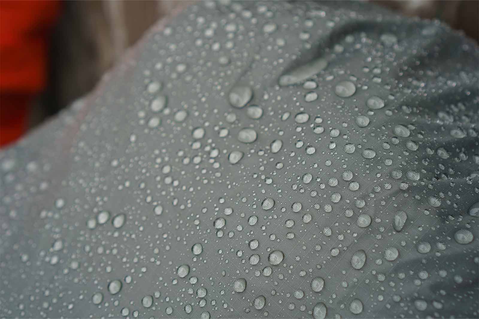 Close-up of rain drops on a waterproof pack cover