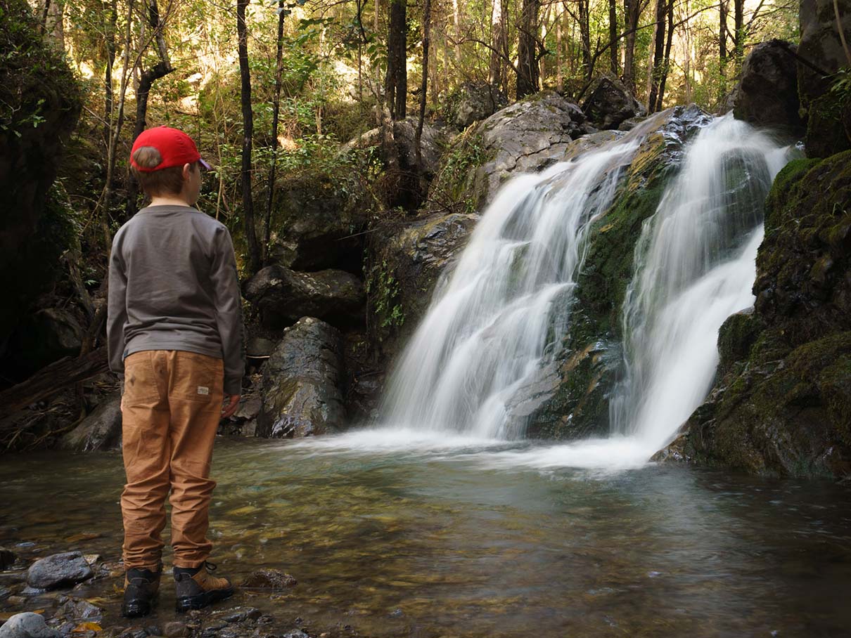 Family at a waterfall in New Zealand's South Island